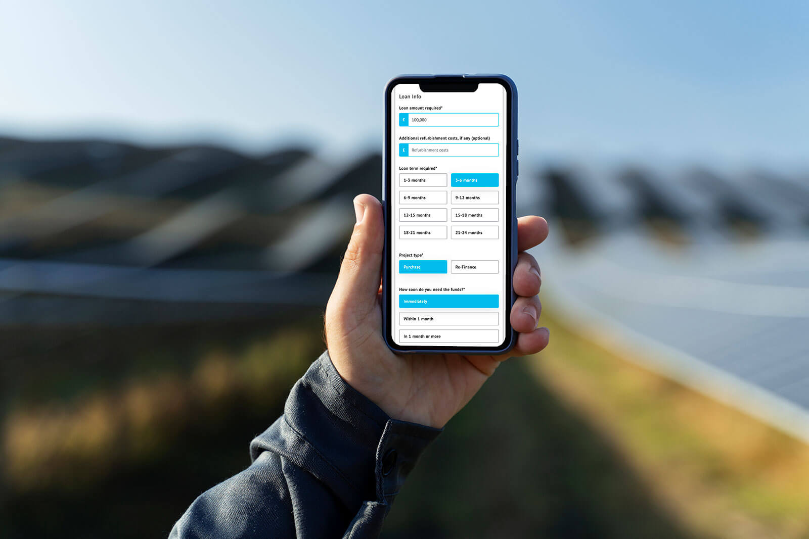 Person holding a phone displaying the Marshfield Capital application.