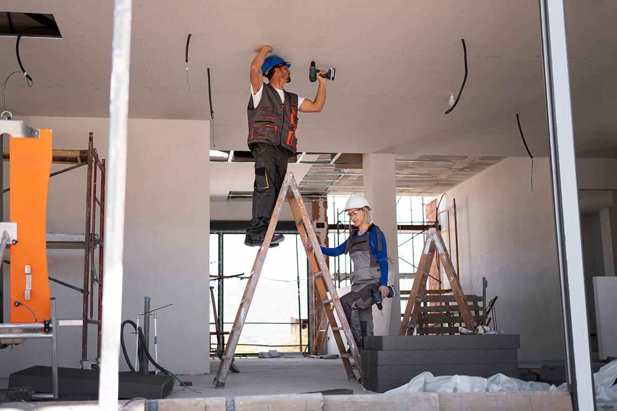Two people doing refurbishment in a house.